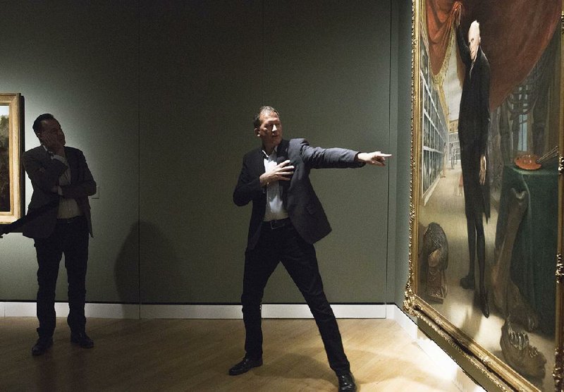 Alan Braddock, associate professor of art history at the College of William & Mary, discusses a piece by Charles Willson Peale entitled “The Artist in His Museum” during a media preview Thursday at Crystal Bridges in Bentonville.  