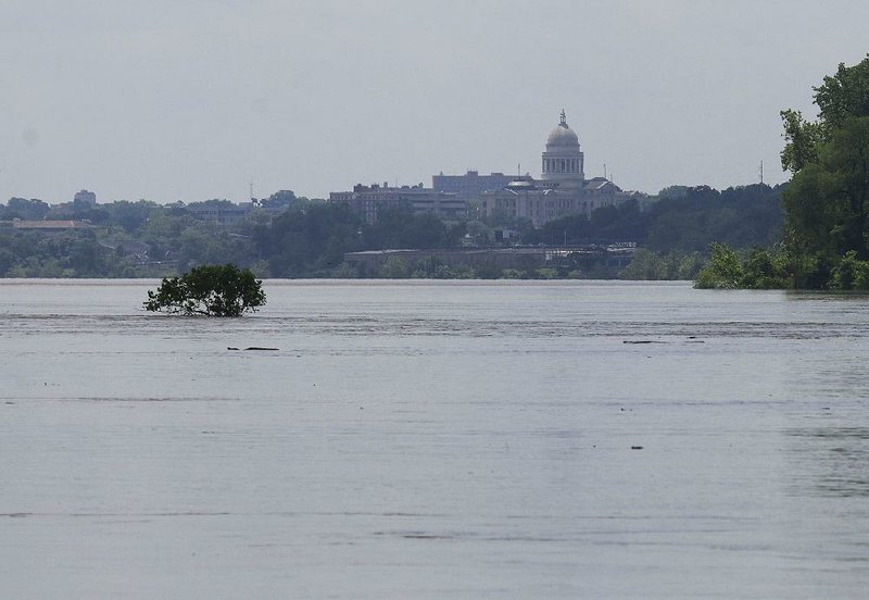 The Arkansas River runs high Thursday morning between Burns Park and the state Capitol as water from Oklahoma continues to flow into Arkansas. The river is expected to reach record highs over the weekend and into next week. 