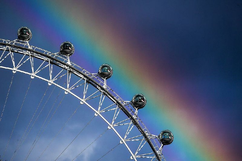 A rainbow appears in the sky near the London Eye ferris wheel, operated by Merlin Entertainments, in London in March. 