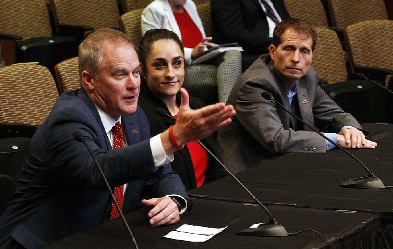 Arkansas Athletic Director Hunter Yurachek (left) was on hand Thursday along with gymnastics Coach Jordyn Wieber (center) and men’s basketball Coach Eric Musselman (right) at the University of Arkansas System board of trustees meeting at the University of Arkansas at Little Rock’s Stella Boyle Smith Concert Hall in Little Rock. The school’s basketball practice facility will be named after former men’s basketball coach Eddie Sutton, who coached the Razorbacks from 1974-85.