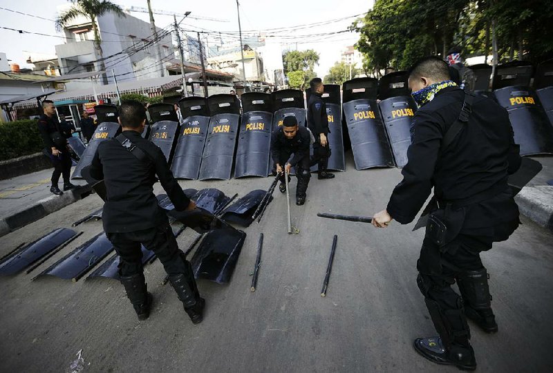 Police officers arrange their riot gear a day after the clash with supporters of Indonesian presidential candidate Prabowo Subianto in Jakarta, on Thursday. 