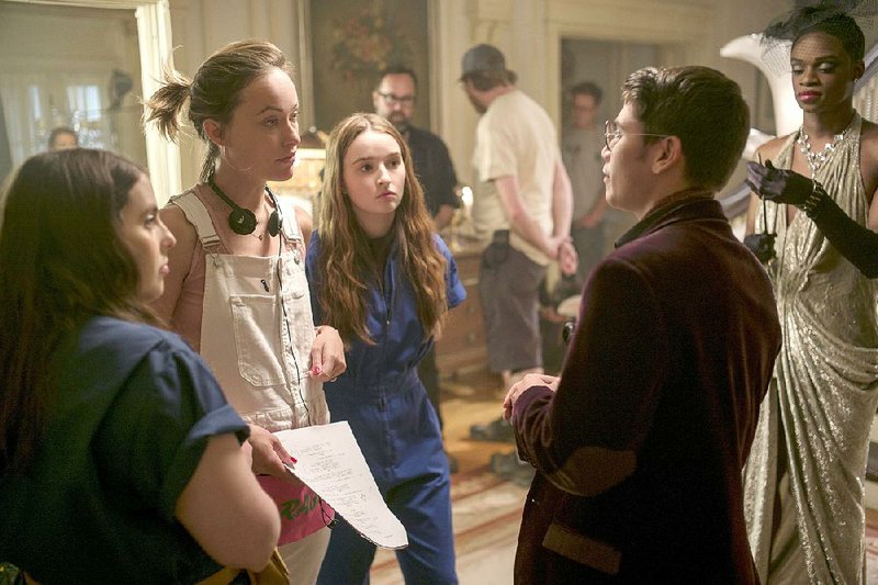 Olivia Wilde (in overalls) consults with (from left) actors Beanie Feldstein, Kaitlyn Dever, Austin Crute and Noah Galvin on the set of Booksmart. 