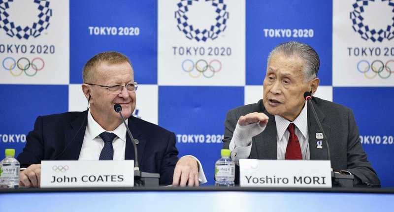 The Associated Press REASSURING OFFICIALS: John Coates, left, chairman of the IOC Coordination Commission for the 2020 Tokyo Olympics and Paralympics, Tokyo Olympic organizing committee President Yoshiro Mori, right, attend a press conference Thursday in Tokyo. A top Olympic official has made a guarantee that should please world sports federations that are concerned that organizers of next year's Tokyo games might be cutting things that federations view as "essential."