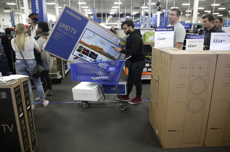 In this Nov. 22, 2018, file photo people wait in line to buy televisions as they shop during an early Black Friday sale at a Best Buy store on Thanksgiving Day in Overland Park, Kan. Best Buy Co., Inc. reports financial results Thursday, May 23, 2019. (AP Photo/Charlie Riedel, File)