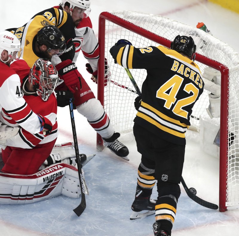 The Associated Press TAP IT IN: Carolina Hurricanes goaltender Petr Mrazek, second from left, of the Czech Republic, looks back as Boston Bruins' David Backes (42) pokes the puck in for a goal on May 12 in Game 2 of the NHL Stanley Cup Eastern Conference final series in Boston.