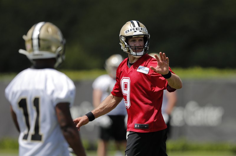 The Associated Press TAKING CHARGE: New Orleans Saints quarterback Drew Brees (9) works out with rookie wide receiver Deonte Harris during NFL practice in Metairie, La., Thursday.