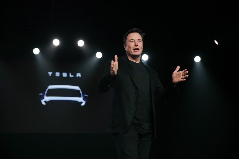 In this March 14, 2019, file photo Tesla CEO Elon Musk speaks before unveiling the Model Y at Tesla's design studio in Hawthorne, Calif. Shares of electric vehicle maker Tesla Inc. fell at the opening bell Thursday, May 23 but recovered into positive territory after an analyst predicted falling demand but Musk told employees that orders are up.  (AP Photo/Jae C. Hong, File)