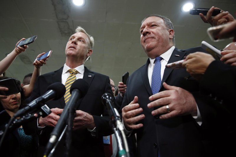 In this May 21, 2019, photo, acting Defense Secretary Patrick Shanahan, left, and Secretary of State Mike Pompeo speak to members of the media after a classified briefing for members of Congress on Iran on Capitol Hill in Washington. U.S. officials say the Pentagon will present plans to the White House to send up to 10,000 more American troops to the Middle East to beef up defenses against potential Iranian threats. The officials said no decision has been made and it&#x2019;s not clear if the White House will approve sending all or just some of the requested forces. (AP Photo/Patrick Semansky)