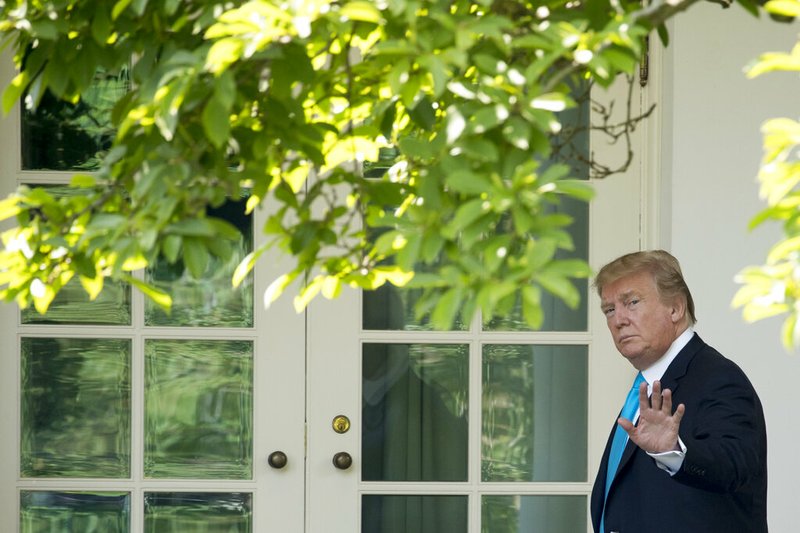 President Donald Trump waves as he walks towards the Oval Office in Washington, Thursday, May 23, 2019, after visiting the annual Flags In ceremony at Arlington National Cemetery. (AP Photo/Andrew Harnik)