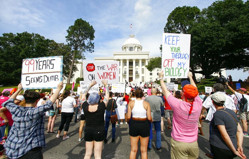 Protesters for women's rights hold a rally on the Alabama Capitol steps to protest a law passed last week making abortion a felony in nearly all cases with no exceptions for cases of rape or incest, Sunday, May 19, 2019, in Montgomery, Ala. (AP Photo/Butch Dill)