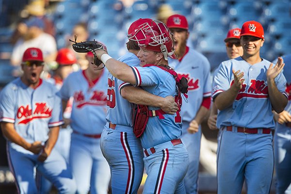 Ole Miss pitcher Parker Caracci and catcher Cooper Johnson embrace after the Rebels defeated Arkansas during the SEC Tournament on Friday, May 24, 2019, in Hoover, Ala.