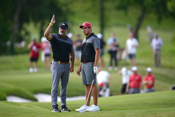 Arkansas men's golf coach Brad McMakin (left) and Julian Perico speak Friday, May 24, 2019, on the fifth fairway during the first day of play in the Men's NCAA Golf Championships at Blessings Golf Club in Fayetteville.
