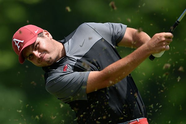 Julian Perico of Arkansas hits Friday, May 24, 2019, onto the 16th green during the first day of play in the Men's NCAA Golf Championships at Blessings Golf Club in Fayetteville.