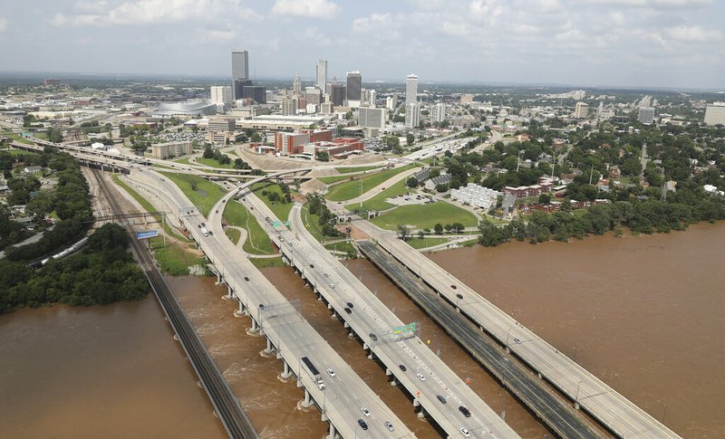 This aerial image shows the Arkansas River with the Tulsa, Okla., skyline after flooding on Thursday, May 23, 2019. Storms and torrential rains have ravaged the Midwest, from Texas through Oklahoma, Kansas, Nebraska, Iowa, Missouri and Illinois, in the past few days. (Tom Gilbert/Tulsa World via AP)