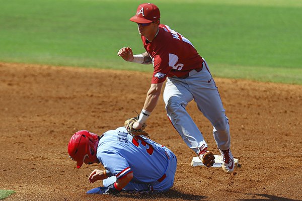 Mississippi's Anthony Servideo (3) is tagged out by Arkansas shortstop Casey Martin (15) as he was caught in a run down for the second out of a double play during the third inning of an NCAA college baseball game at the Southeastern Conference Tournament, Friday, May 24, 2019, in Hoover, Ala. (AP Photo/Butch Dill)

