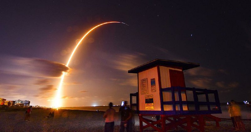 In a long-exposure photo, a Falcon 9 SpaceX rocket lifts off late Thursday at Cape Canaveral in Florida. 