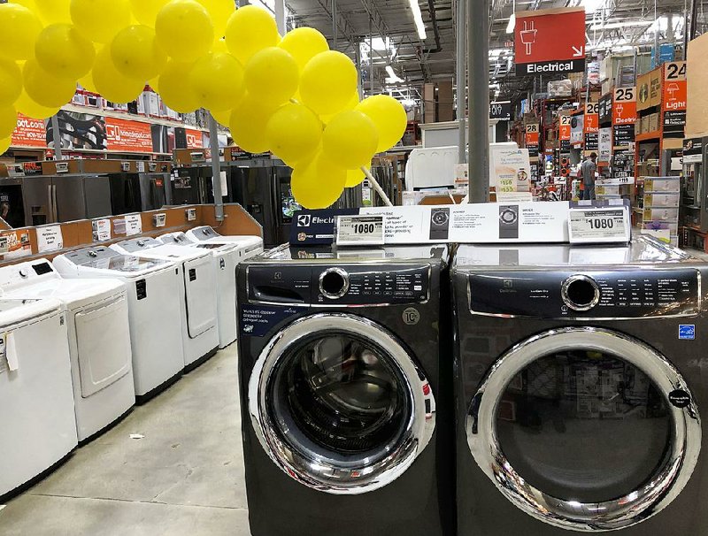 Friday’s data from the Commerce Department suggest consumers are purchasing fewer big-ticket items like these laundry machines at a Home Depot store in Miami Lakes, Fla. 