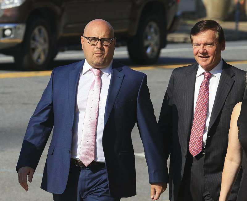 Former Arkansas Sen. Jeremy Hutchinson (left) arrives Tuesday morning at the federal courthouse in Little rock with his father, former U.S. Sen. Tim Hutchinson. Hutchinson plead not guilty to 12 counts of wire and tax fraud. 