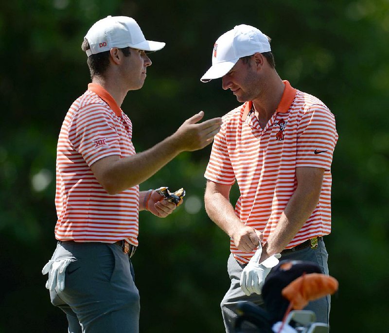 Oklahoma State’s Austin Eckroat (right) and Matthew Wolff speak on the No. 14 tee box Saturday at Blessings Golf Club in Fayetteville during the second round of stroke play at the NCAA Men’s Golf Championships. Eckroat leads after firing his second consecutive 3-under 69. Wolff is in second after shooting a 6-under 66 on Saturday, which tied the course record.