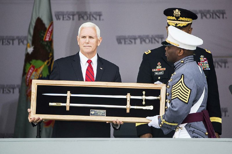 Vice President Mike Pence holds a sword presented as a gift during Saturday’s graduation ceremony at the U.S. Military Academy in West Point, N.Y. 