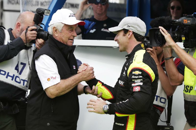 Car owner Roger Penske (left) congratulates driver Simon Pagenaud last week after he won the pole for today’s Indianapolis 500. Team Penske has won Indy a record 17 times.