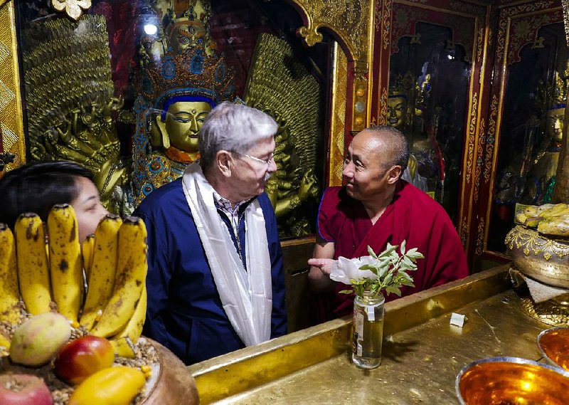 Terry Branstad (center), U.S. ambassador to China, talks with a monk Thursday at the Jokhang Temple in Lhasa in China’s Tibet Autonomous Region. Branstad was given access to religious and cultural sites in the tightly controlled area. 