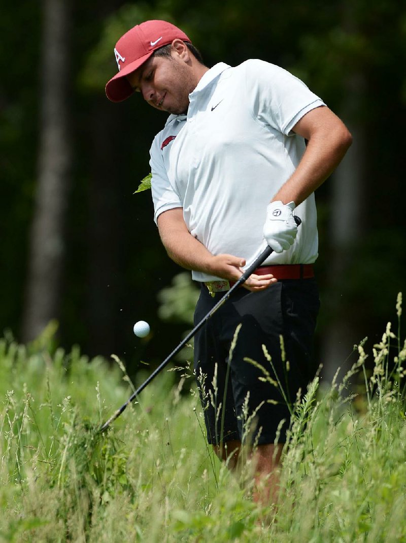 Julian Perico of Arkansas hits out of deep grass on the edge of the 10th fairway during the second day of play Saturday in the NCAA Men’s Golf Championships at Blessings Golf Club in Fayetteville. Perico, who was named to the PING All-Central Region team, shot a 3-over 75 and is tied for 23rd place.