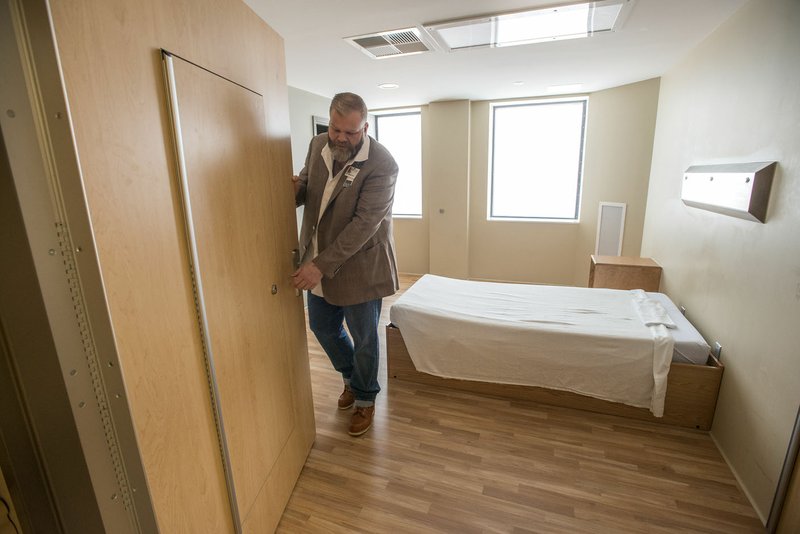 NWA Democrat-Gazette/SPENCER TIREY Dr. Brian Hyatt shows the special room doors May 17 allowing orderlies and doctors to enter the room at Northwest Medical Center in Springdale if a patient tries to barricade in the room. Northwest is planning to add 30 beds to its behavioral health unit.