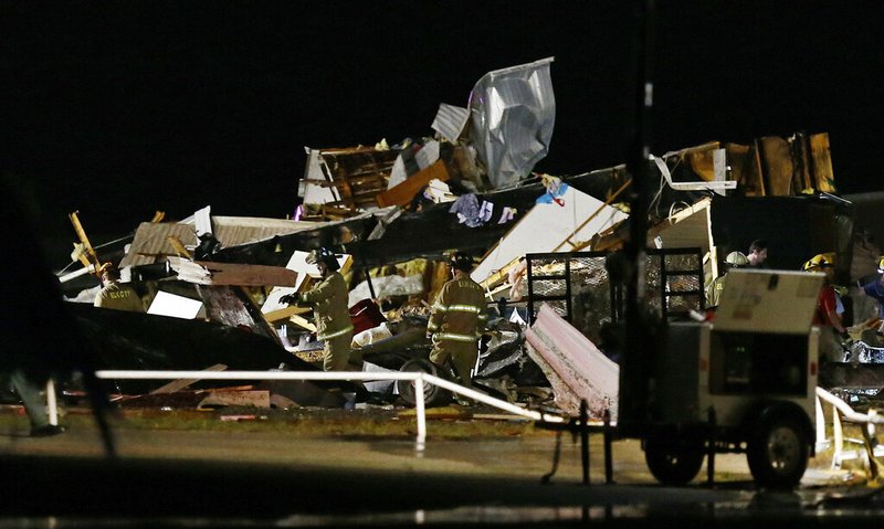 Emergency workers search through debris from a mobile home park, Sunday, May 26, 2019, in El Reno, Ok., following a likely tornado touchdown late Saturday night. (AP Photo/Sue Ogrocki)