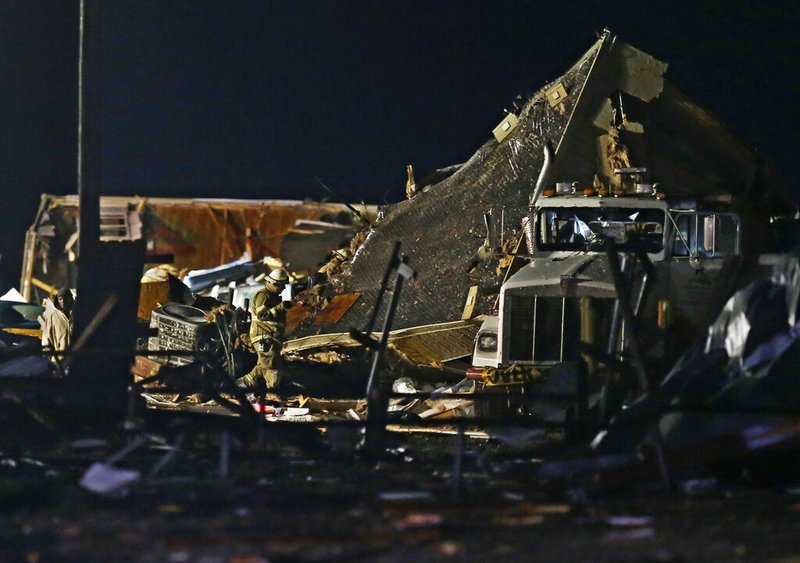 Emergency workers search through debris from a mobile home park, Sunday, May 26, 2019, in El Reno, Okla., following a tornado touchdown late Saturday night.