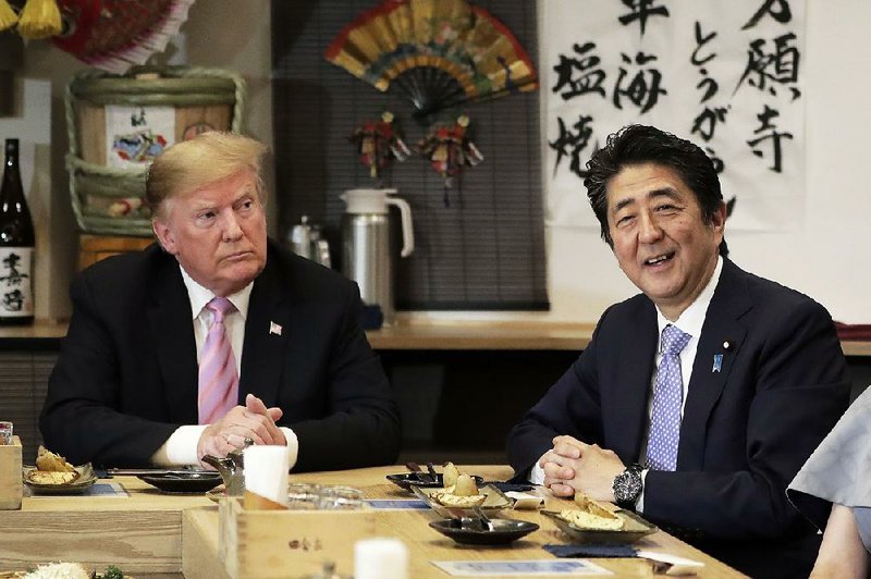 President Donald Trump and Japanese Prime Minister Shinzo Abe have dinner Sunday at a restaurant in the Roppongi district of Tokyo. 