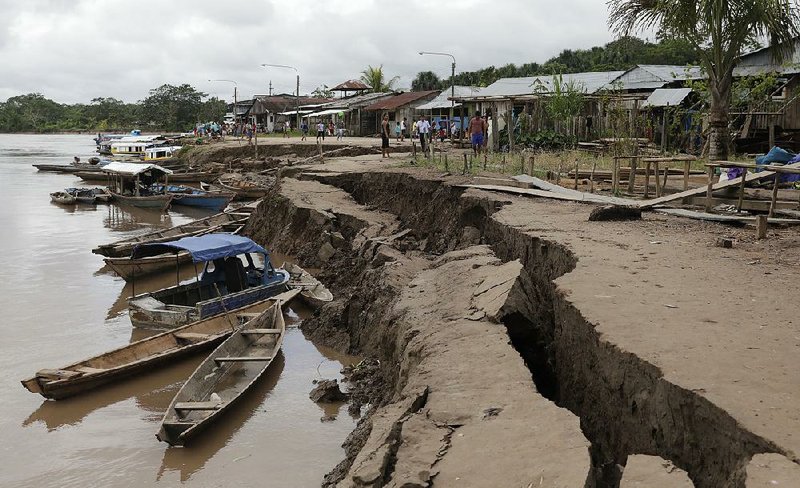 The bank of the Huallaga River cracked Sunday during the earth- quake on the outskirts of Yurimaguas, Peru. 