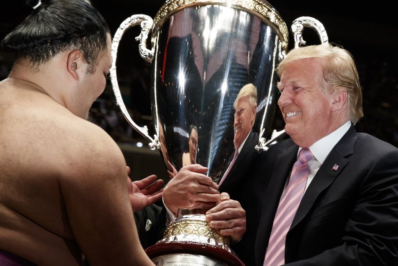 President Donald Trump presents the &quot;President's Cup&quot; to Tokyo Grand Sumo Tournament winner Asanoyama, at Ryogoku Kokugikan Stadium, Sunday, May 26, 2019, in Tokyo. (AP Photo/Evan Vucci)