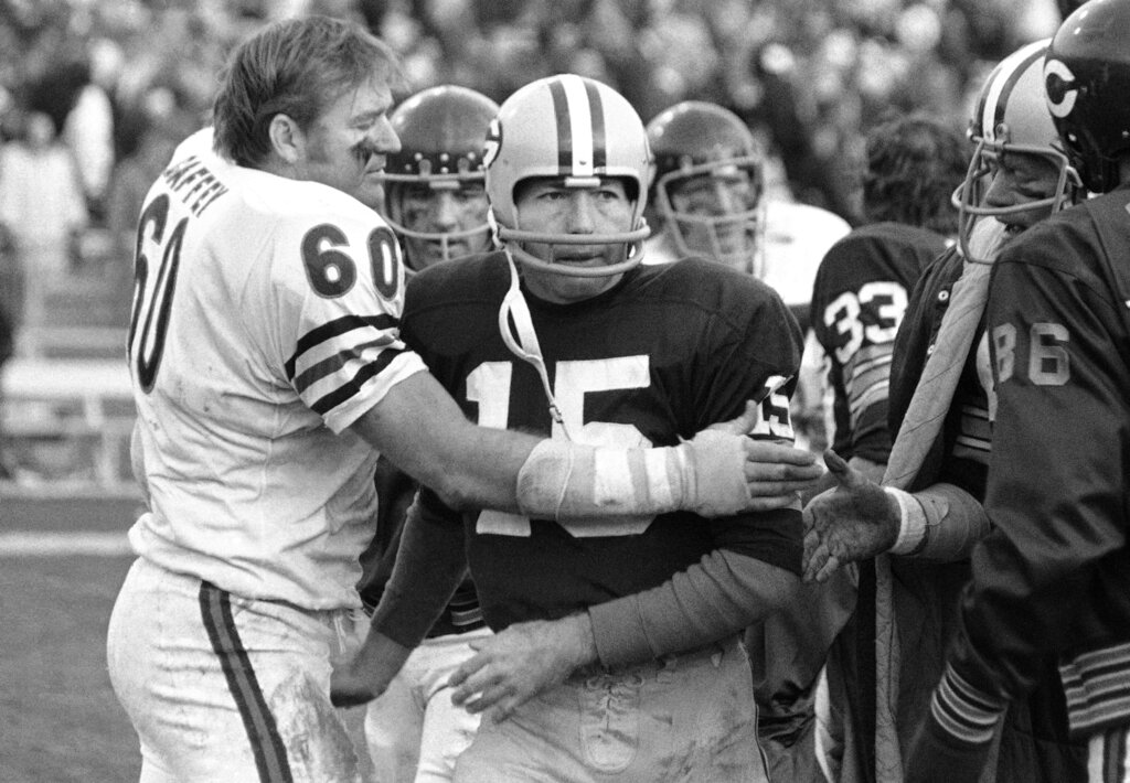 Green Bay Packers quarterback Bart Starr is led away from the team?s  clubhouse by his son, three-year-old Bret, following a training camp  session, July 19, 1967 in Green Bay, Wis. Bret often