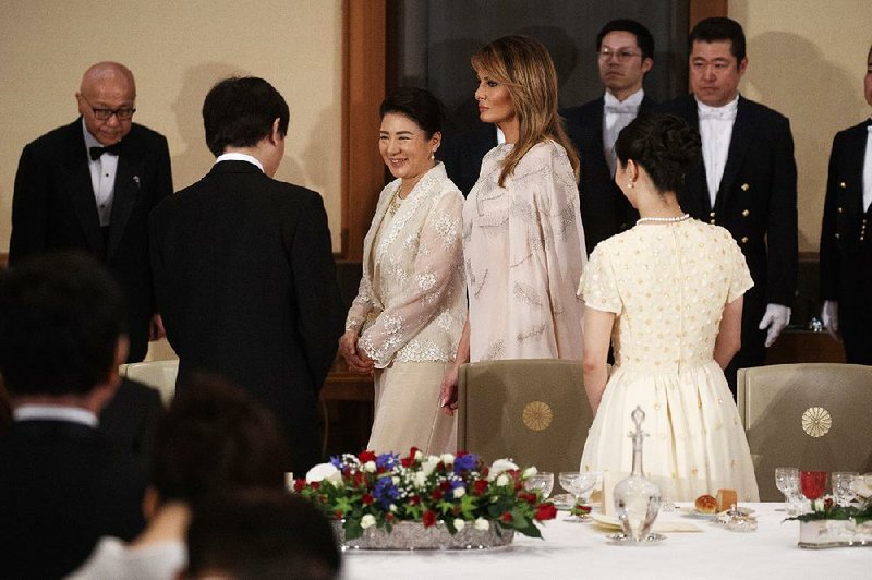 Japanese Empress Masako and first lady Melania Trump arrive for a State Banquet at the Imperial Palace, on Monday in Tokyo. 