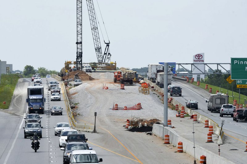NWA Democrat-Gazette/CHARLIE KAIJO Traffic drives by near a construction site, Friday, May 24, 2019 at the I-49 off-ramp on Walnut in Bentonville. 

