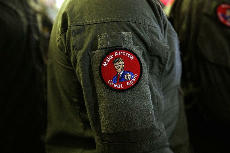 A USS Wasp crewman sports the “Make Aircrew Great Again” patch, with an image of President Donald Trump, during Trump’s visit Tuesday to the assault ship in Japan. 