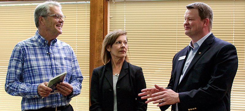 GENEROUS DONATION: From left, Dr. Jack Porter, chairman of the CCMC board, and Lynn Blankenship, executive director of CCMC, chat with Brent Atkins, vice president and commercial loan officer for Simmons Bank, on Tuesday after the local branch of the bank presented $10,000 to the nonprofit.