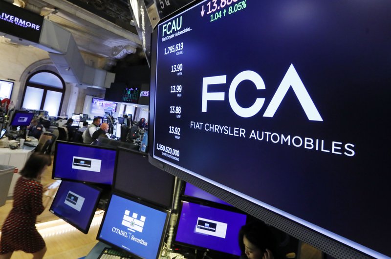 The Fiat Chrysler Automobiles logo appears above a post on the floor of the New York Stock Exchange, Tuesday, May 28, 2019. Fiat Chrysler is proposing a merger with French carmaker Renault aimed at saving billions of dollars for both companies. (AP Photo/Richard Drew)