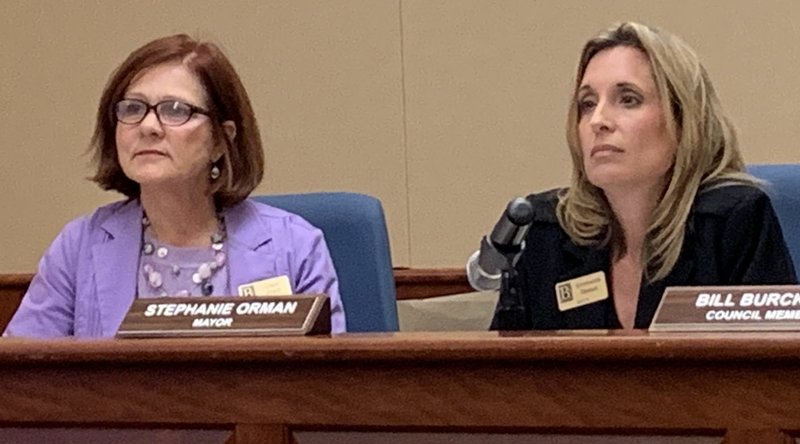 Cindy Acree, council member, (left) and Mayor Stephanie Orman listen to public comments Tuesday at a Bentonville City Council Meeting.