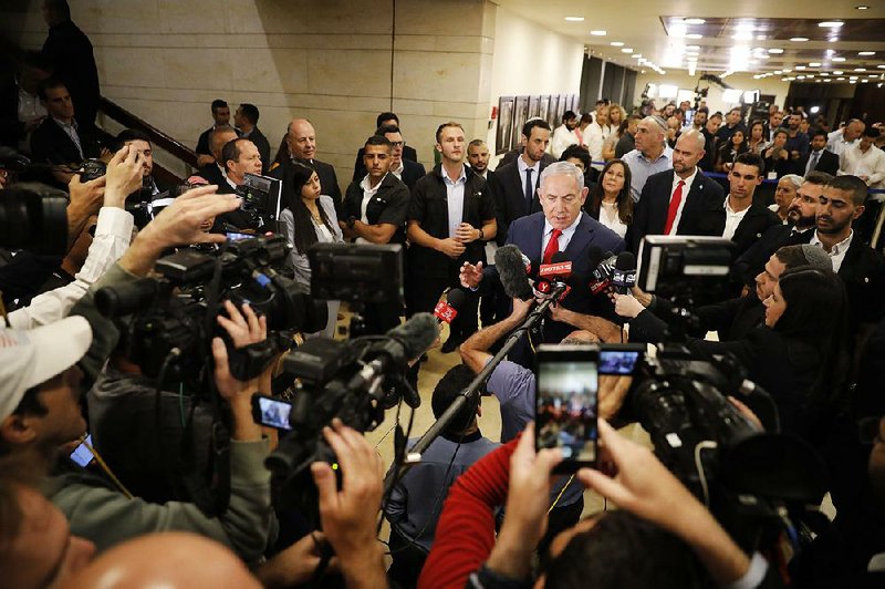 Israeli Prime Minister Benjamin Netanyahu speaks with reporters early today after he was unable to form a governing coalition as discord with his intended allied parties resulted in a deadlock. 