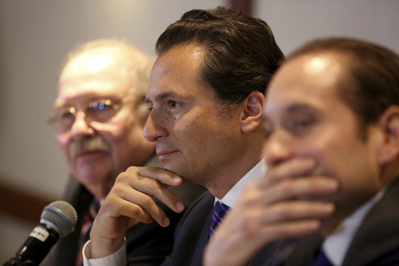  In this Aug. 17, 2017 file photo, flanked by lawyer Javier Coello Trejo, left, Emilio Lozoya, former head of Mexico's state-owned oil company Pemex, attends a press conference, in Mexico City.  (AP Photo/Gustavo Martinez Contreras, File)