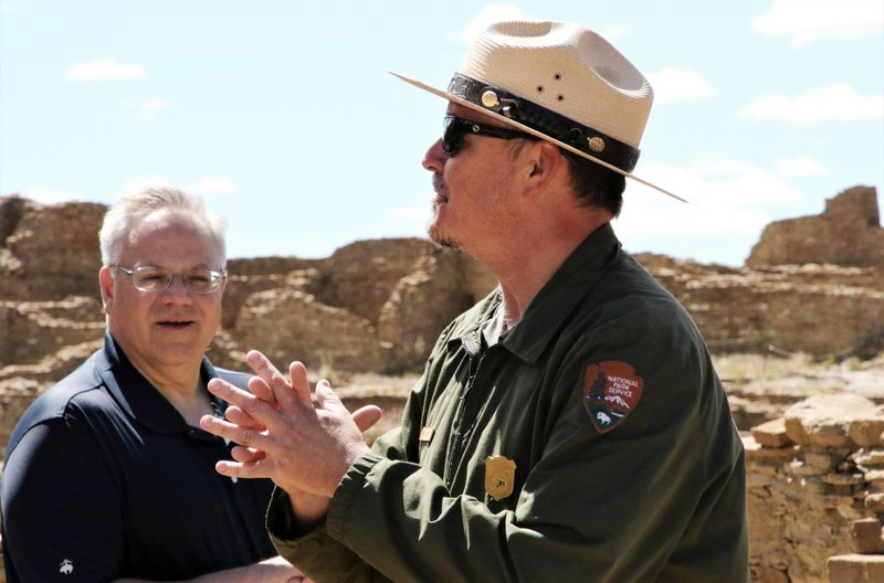 U.S. Interior Secretary David Bernhardt listens while Chaco Culture National Historical Park Chief of Interpretation Nathan Hatfield talks during a tour of Pueblo Bonito in San Juan County, N.M., Tuesday, May 28, 2019. Bernhardt has met with tribal leaders Tuesday who are supporting legislation to prevent drilling on land they consider sacred around Chaco Culture National Historical Park. (Hannah Grover/The Daily Times via AP)