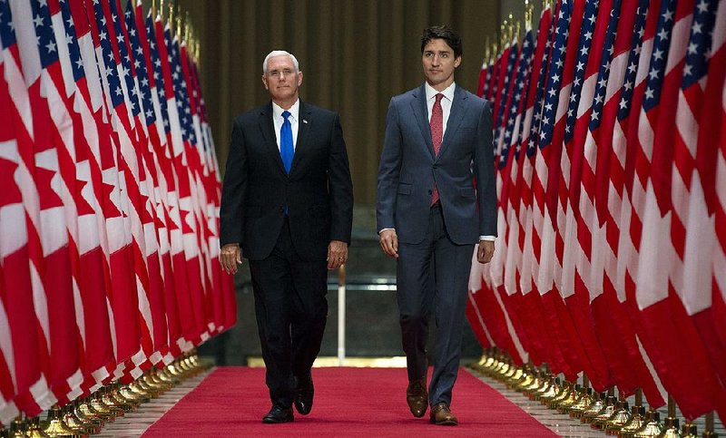 Vice President Mike Pence (left) and Canadian Prime Minister Justin Trudeau head to a joint news conference Thursday in Ottawa after discussions on advancing a new North American trade pact. 