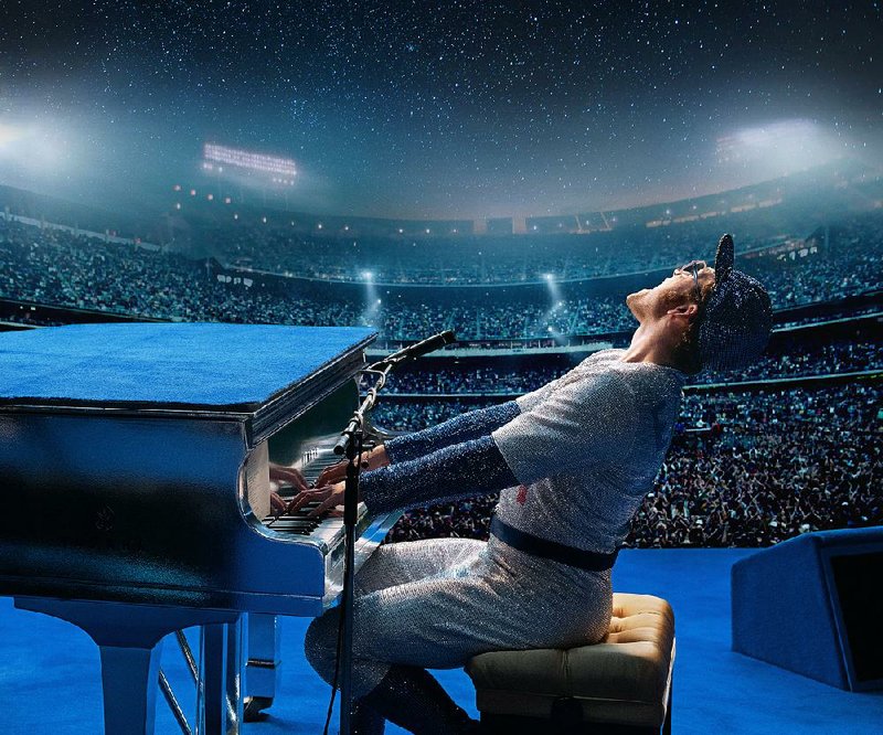 Just out of the hospital in 1975, British pop singer Elton John (Taron Egerton) performs in a sequinned baseball outfi t at Los Angeles’ Dodger Stadium in Dexter Fletcher’s impressionistic bio-pic Rocketman.