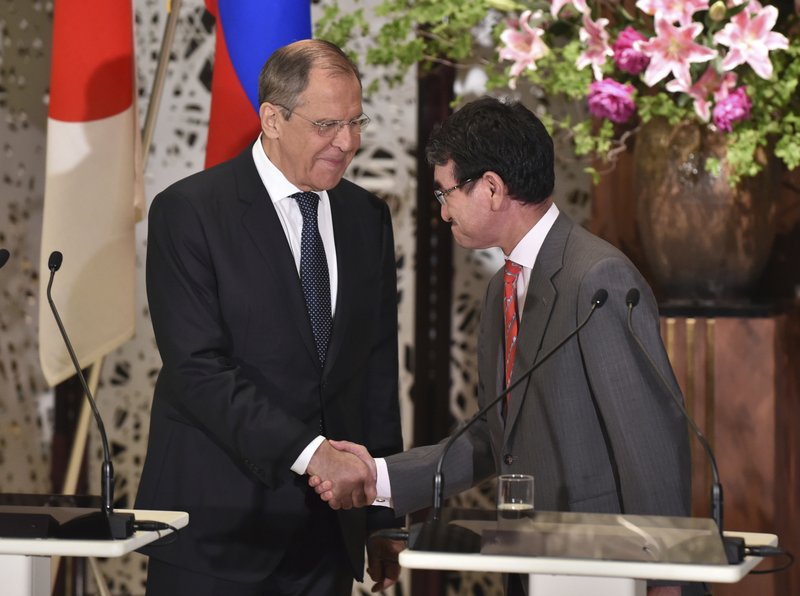 Russia's Foreign Minister Sergei Lavrov, left, and Japan's Foreign Minister Taro Kono shake hands after their 2+2 joint press conference at the Iikura Guest House in Tokyo, Thursday, May 30, 2019. (Kazuhiro Nogi/Pool