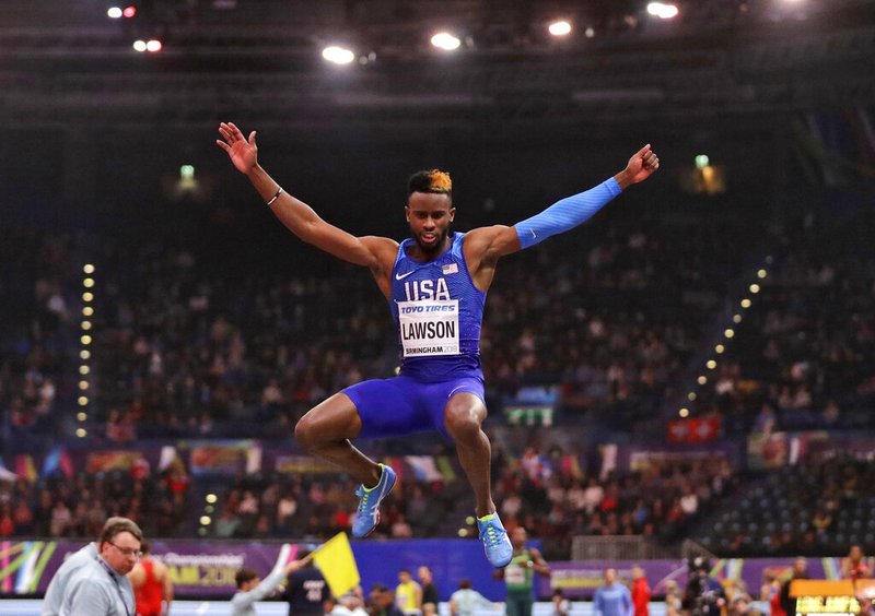 In this March 2, 2018, file photo, United States' Jarrion Lawson makes an attempt in the men's long jump final at the World Athletics Indoor Championships in Birmingham, Britain. Paul Doyle, the agent for Jarrion Lawson told The Associated Press on Friday, May 31, 2019, that the American long jumper and sprinter is expected to receive a four-year suspension for a failed doping test they maintain is tied to contaminated meat. (AP Photo/Matt Dunham, File)