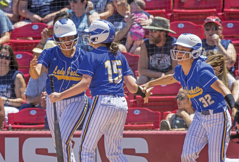From left, Kenli Bolin, Bailee Hall and Lauren McGinley celebrate after Bolin and McGinley score on a hit by Kassie Martin (not pictured) to take the lead over Greenwood in the sixth inning of the Lady Yellowjackets Class 5A state-championship win May 17 at Bogle Park in Fayetteville.