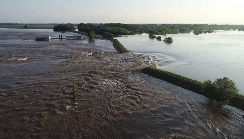 In this aerial image provided by Yell County sheriff's office, water rushes through the levee along Arkansas River in Dardanelle on Friday, May 31, 2019. 