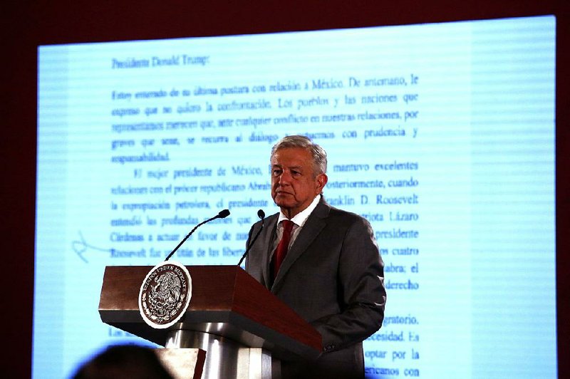 Mexican President Andres Manuel Lopez Obrador, shown Friday at his daily press conference in Mexico City, said Mexico will not respond to tariff threats by President Donald Trump but will push for dialogue instead. 